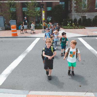 Kindergarten children group walking on crosswalk at Charles Street in Boston.
