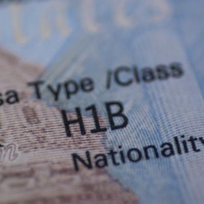 Stamp of an H1B worker's visa on a passport.
