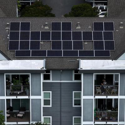 Aerial view of solar panels are on the roof of an apartment complex in California.