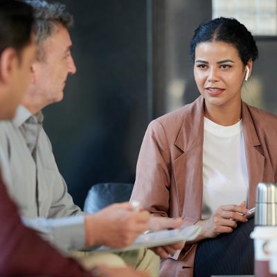 A female chief marketing officer in a meeting with her colleagues.