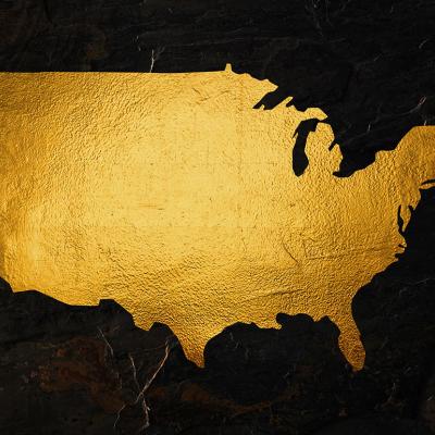 A map of the United States rendered in gold foil.