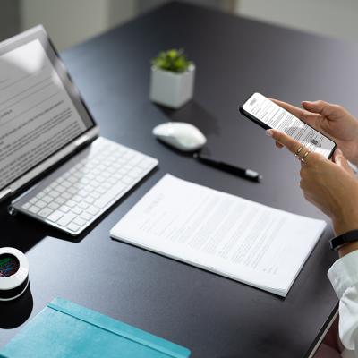 Employee at work manually scanning a document with a phone.