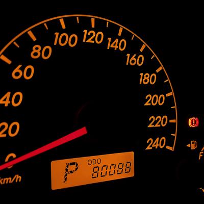 A car's orange-colored speed odometer displaying 80,088km.