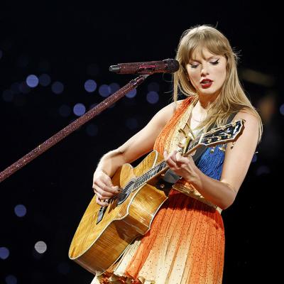 Taylor Swift performs on stage with her guitar during The Eras Tour at Rogers Centre in Toronto City, Ontario.