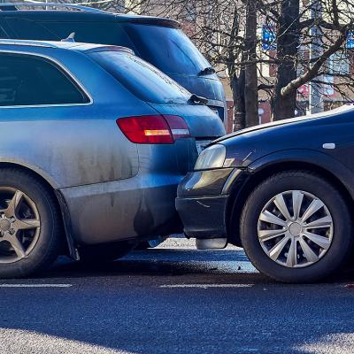 Two cars crashed on a street.