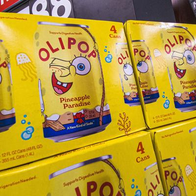 Boxes of OLIPOP's collaboration probiotic drink with Spongebob Squarepants 'Pineapple Paradise' on display on a grocery store.