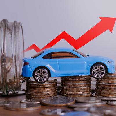 Increase price of car depicted by a small figure of a car over a stack of coins with a red upwards arrow.