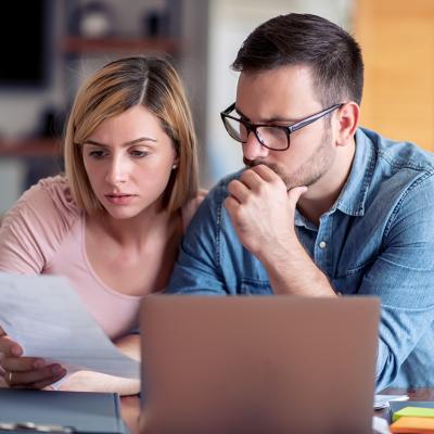A couple analyzing finance documents.