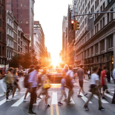 A busy crosswalk in a metro area.