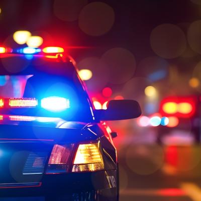 Police car at night in an urban environment.