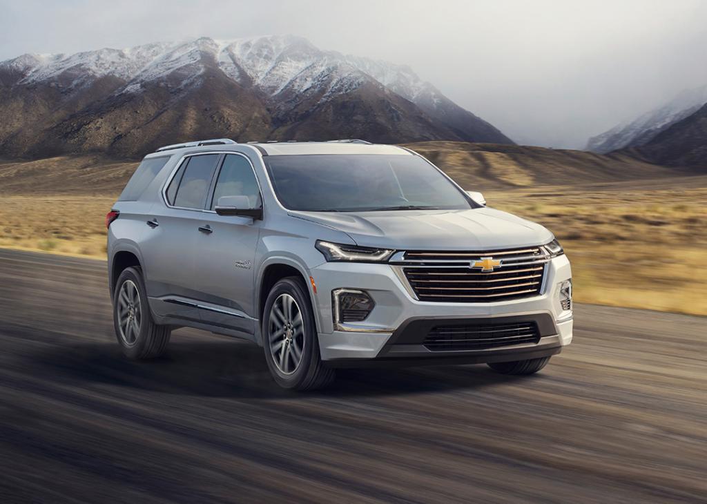 Silver 2022 Chevrolet Travere driving on road with moutnains in the background.