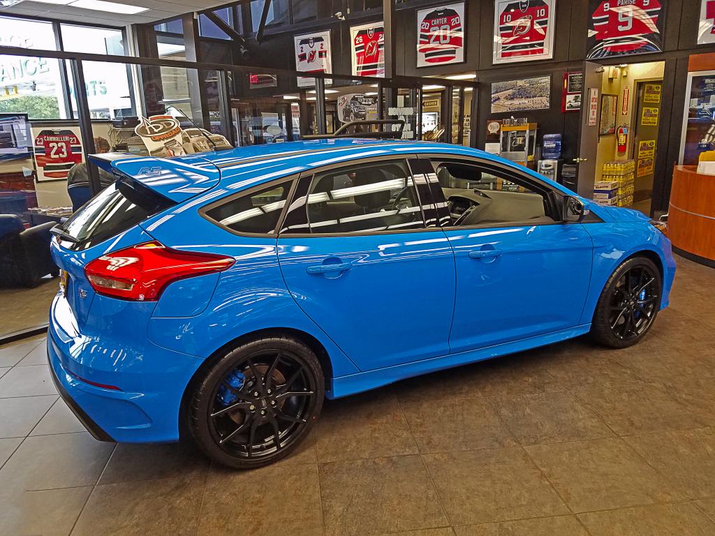 2017 Nitrous Blue Ford Focus RS coupled to a 350-horsepower 2.3L EcoBoost® engine, 5-door Hatchback in the Ford dealership's showroom. 
