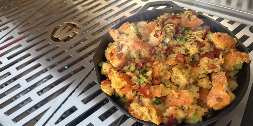 Torn bread with bacon herb dressing served in an iron skillet.