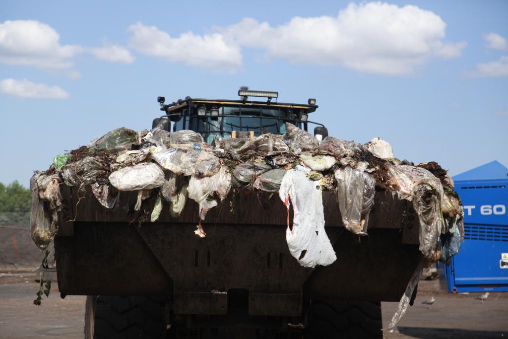 Unsorted organic material is moved to a sorting machine that removes plastic bags at the Staten Island Composting Facility in New York City. 