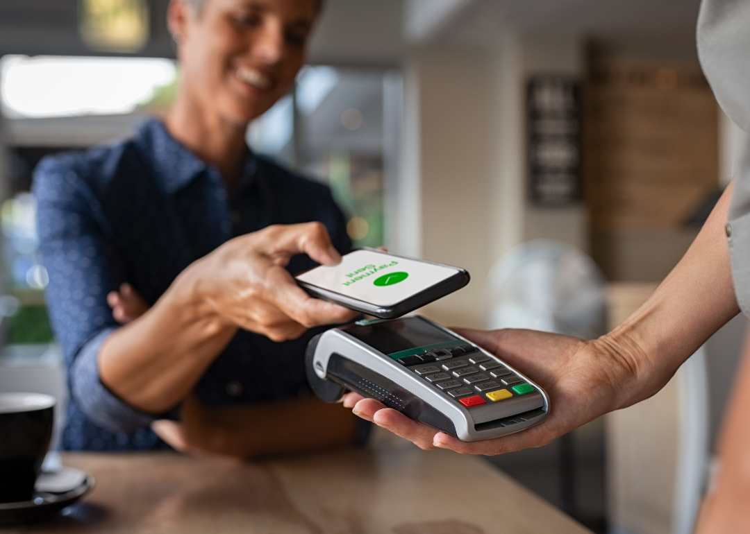 Woman paying bill with smartphone