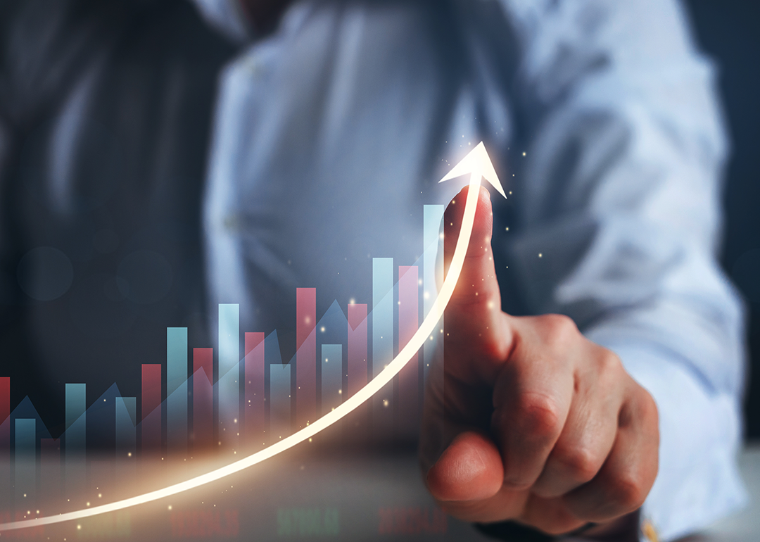Businessperson finger pointing arrow graph.