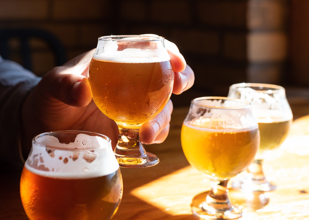 Person holding glass of beer at sampling.
