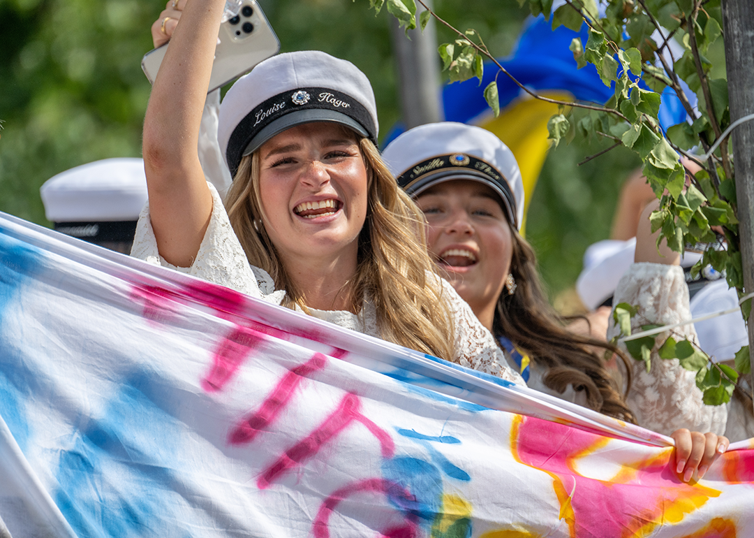Swedish students celebrating in graduation parade.