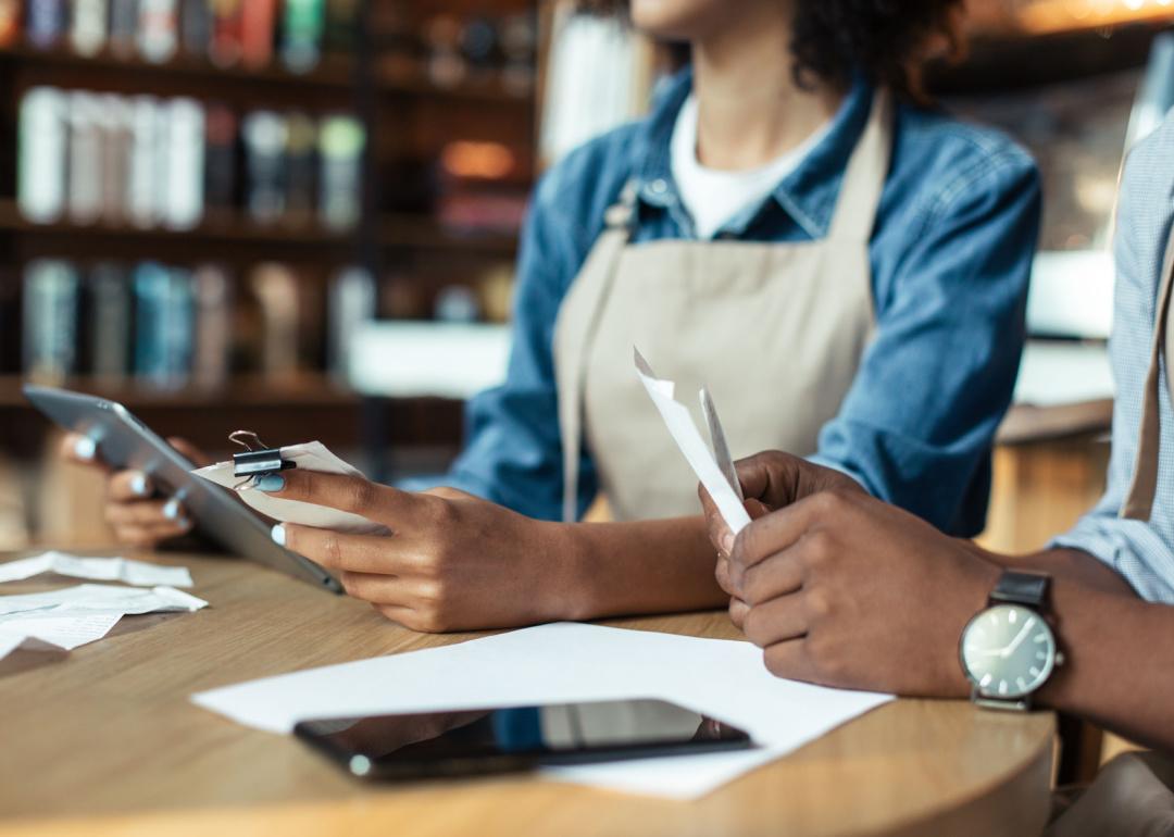 Small business owners reviewing receipts.