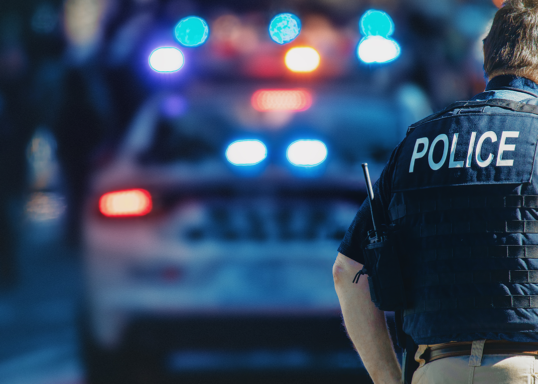 Policeman and police car in the background.