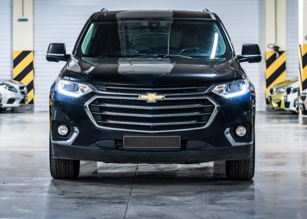 Chevrolet Traverse II front view with headlights on.