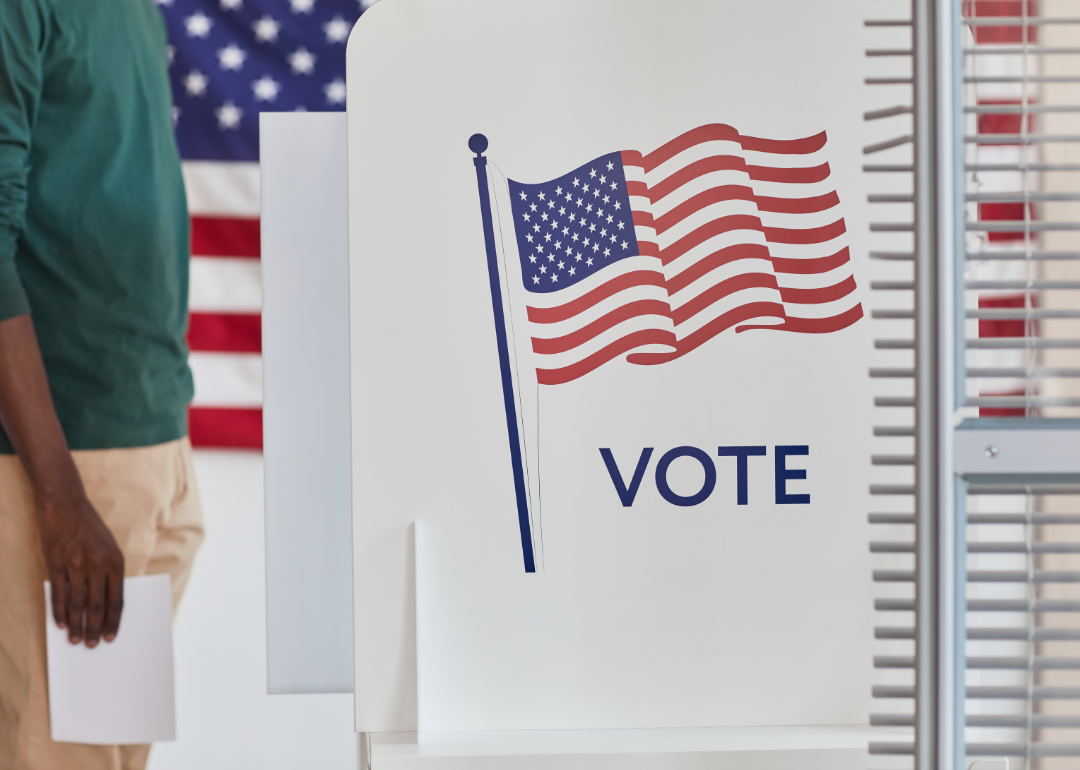 Closeup of man with ballot at polling station