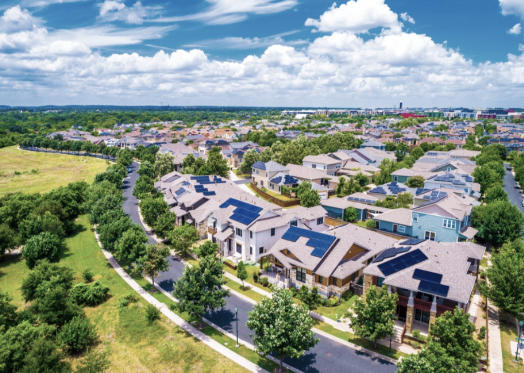 Aerial view of large homes in summer.
