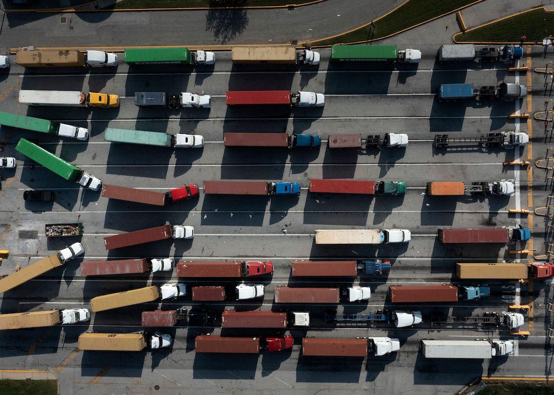 Trucks transport cargo containers at the Port of Baltimore in Baltimore, Maryland, on Oct. 14, 2021.