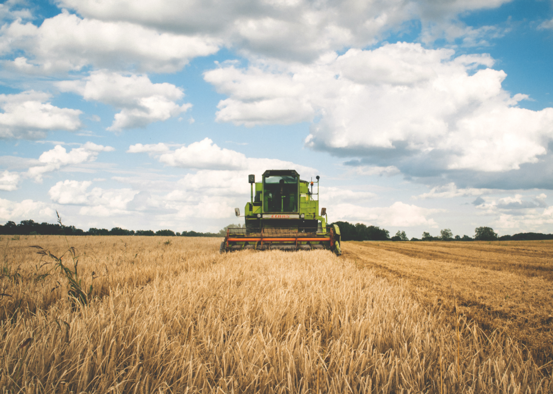 Tractor moves across dry field