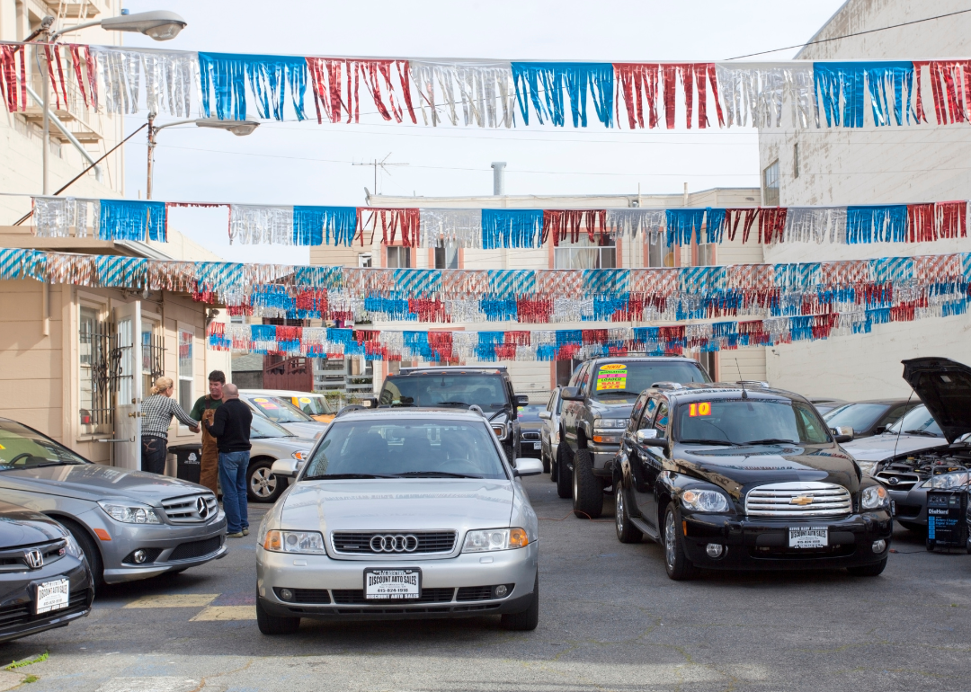 Used cars sit on a dealership lot.