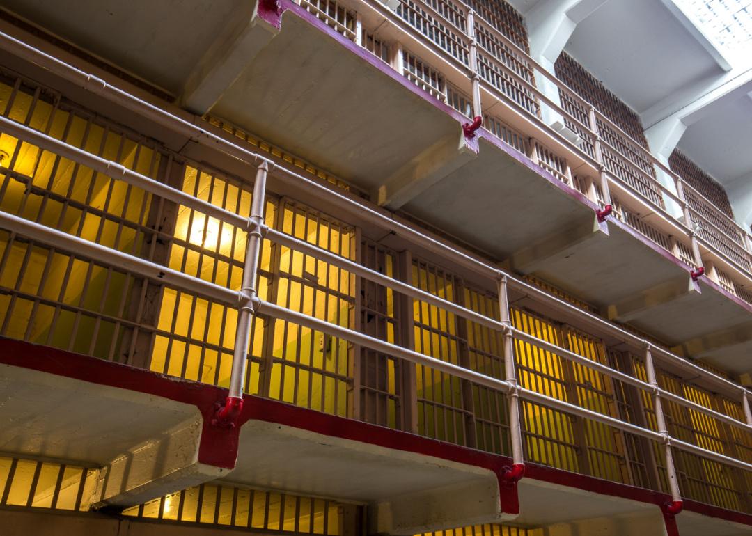 Rows of illuminated prison cells.