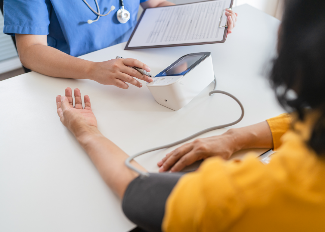 Doctor checking patient's blood pressure.