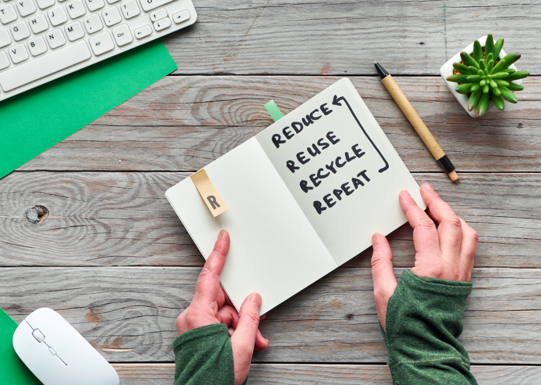Person using zero-waste planner at desk.