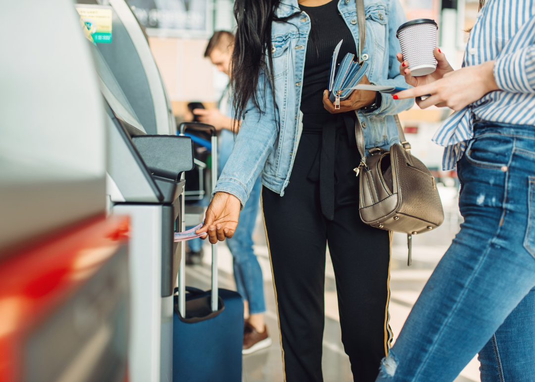 Tourists taking cash out of an airport ATM