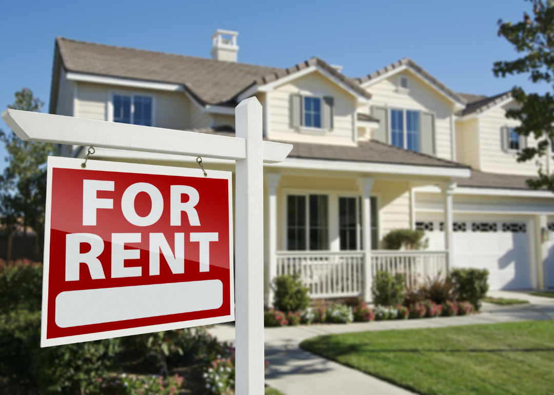 A home with a for rent sign in front