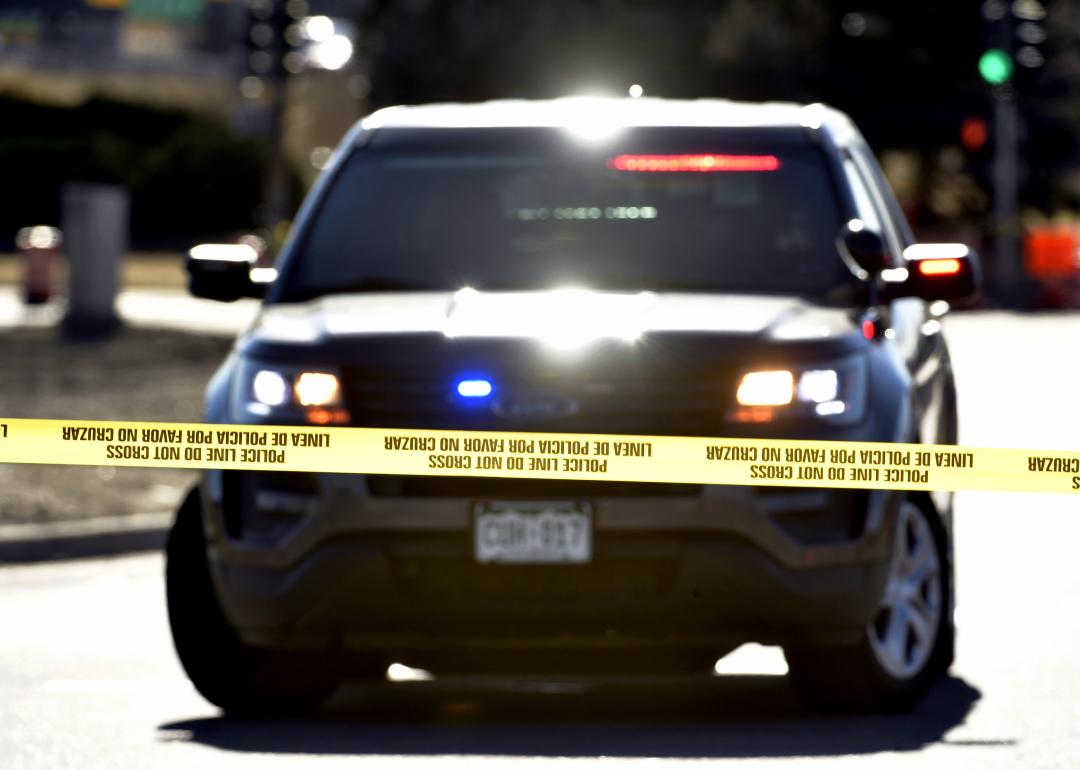 Police officers investigate one of several crime scenes from a shooting spree at 8th Avenue and Zuni Street on December 28, 2021 in Denver, Colorado. A disabled vehicle with a flat tire and shot out window remains in the intersection. A suspect went on a shooting spree on Monday night that spanned two cities, Lakewood and Denver, and claimed the lives of four people and wounded three people including a Lakewood police officer.