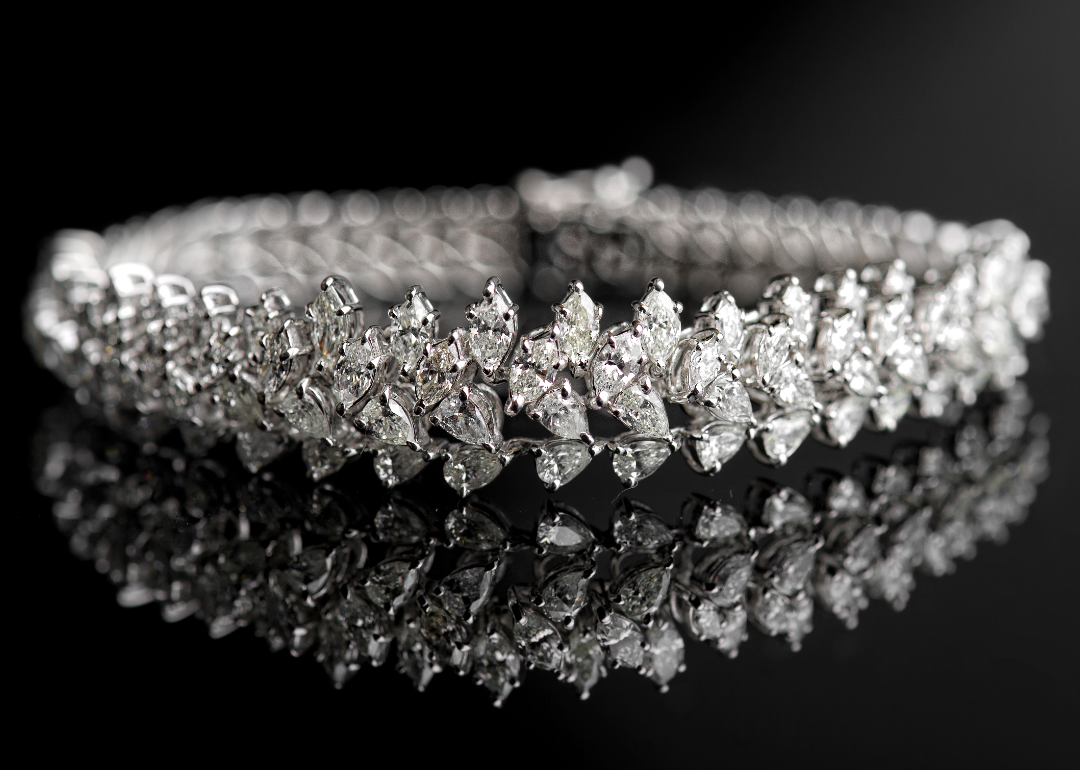 A diamond bracelet shown against a black backdrop.