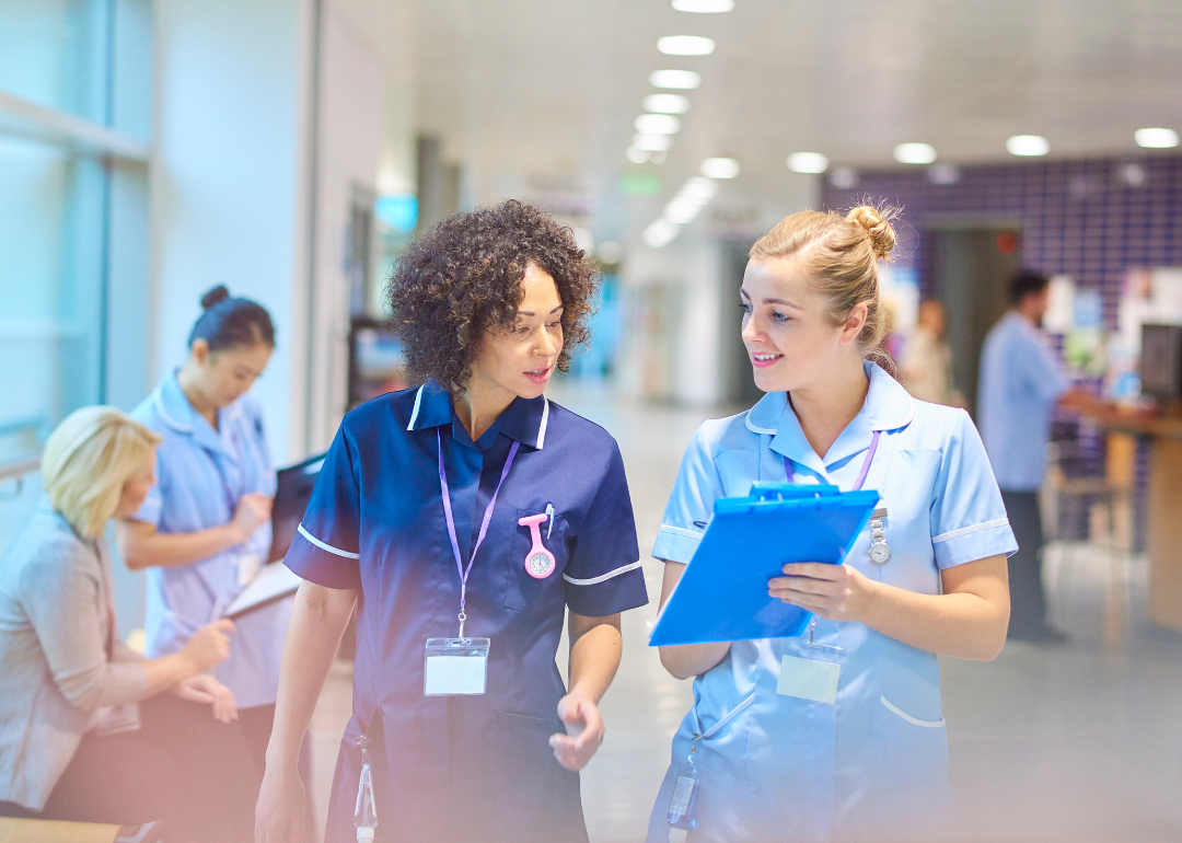 Two nurses comparing notes