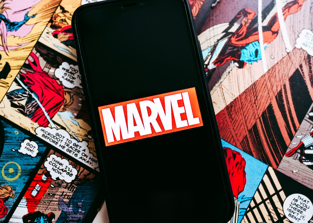 Marvel comics logo on the background of comic pages