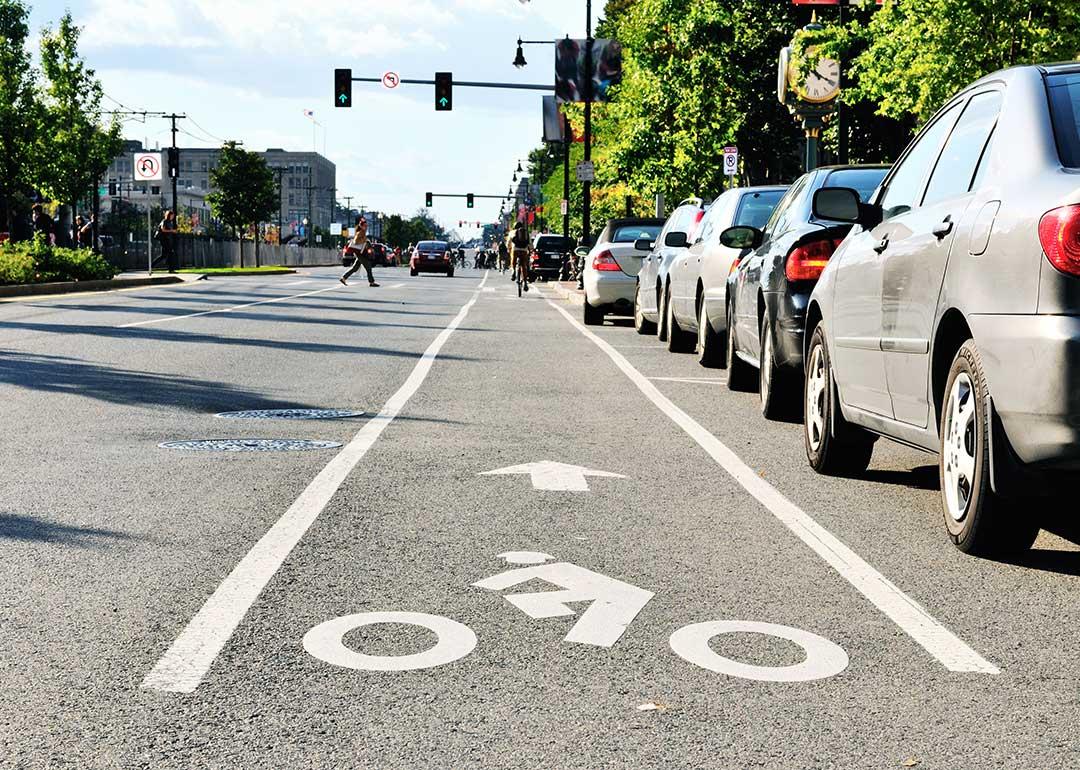 low angle view of road with bike lane, parking and drivers