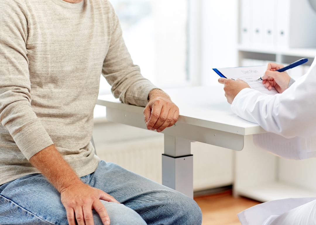 An older man consulting with a doctor