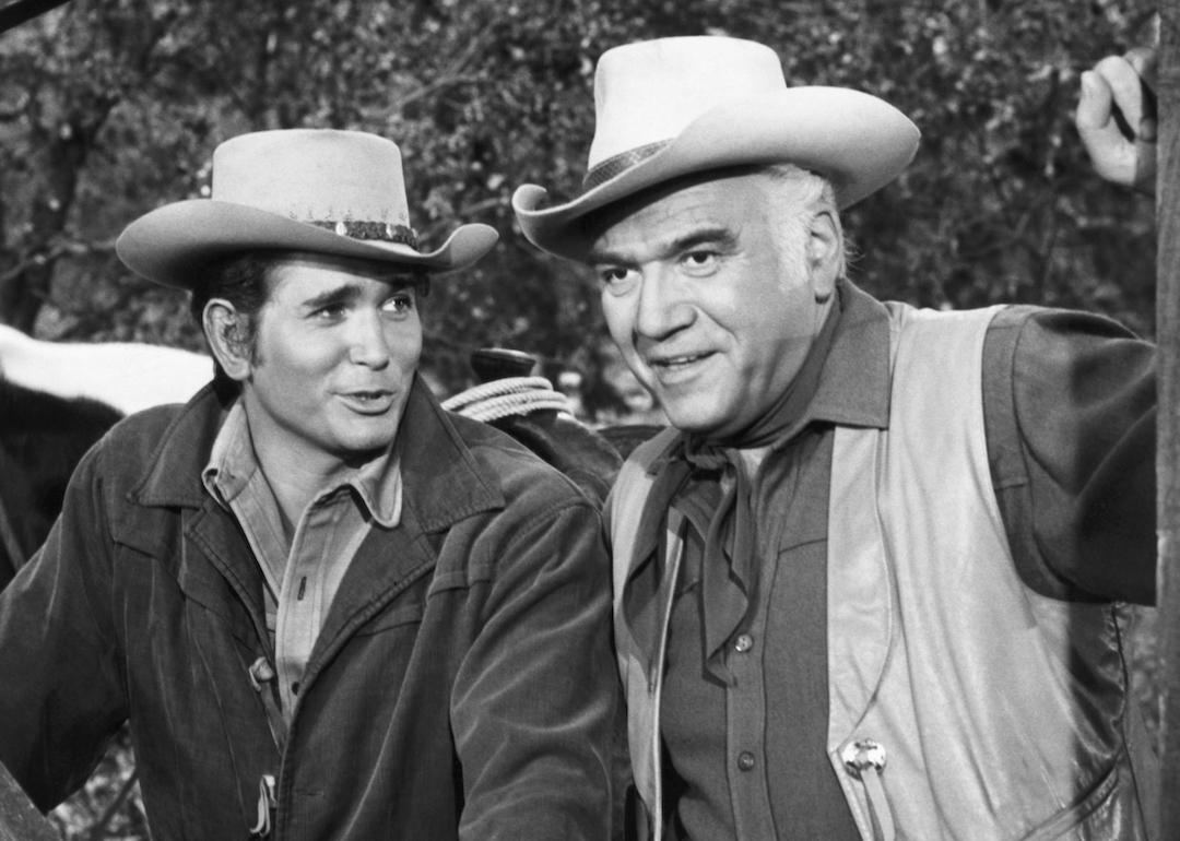 Actor Michael Landon (left) as Little Joe and actor Lorne Greene (right) as Ben Cartwright on an episode of the Western TV series 'Bonanza.'