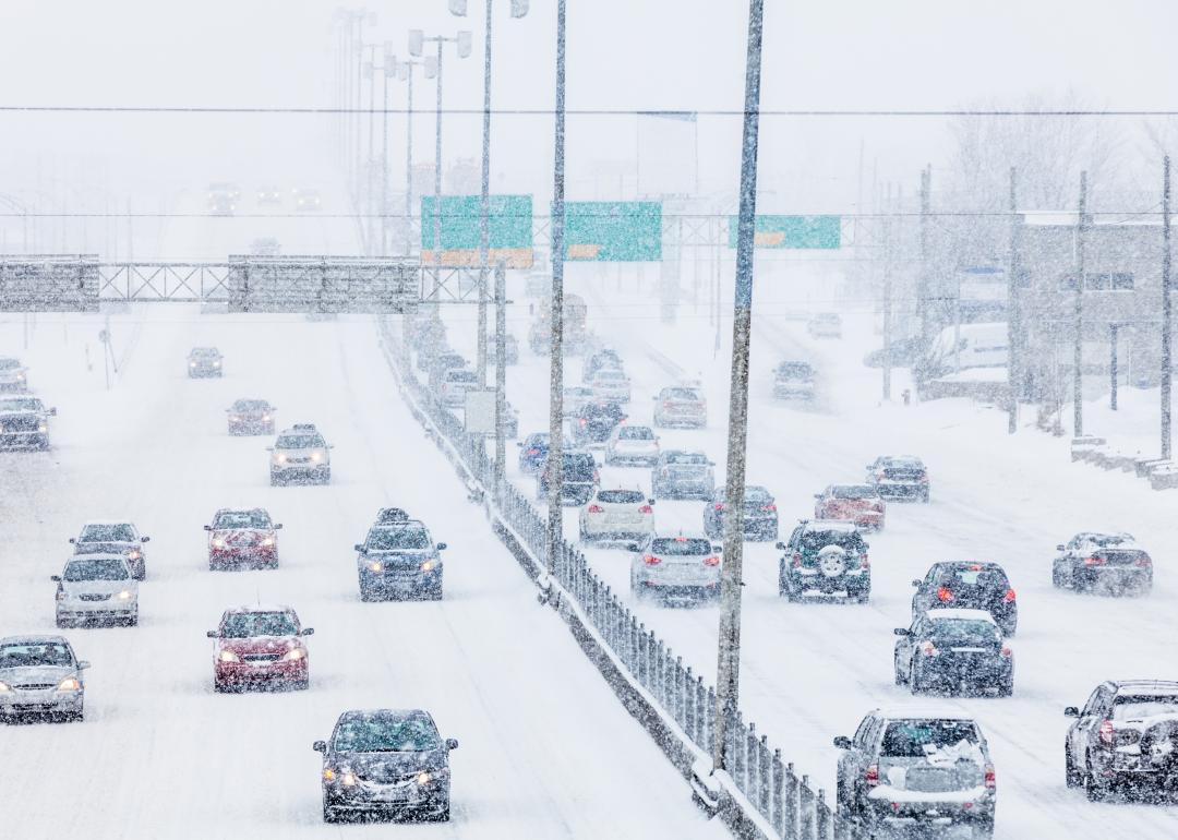 view of cars driving on freeway in both directions in blizzard conditions
