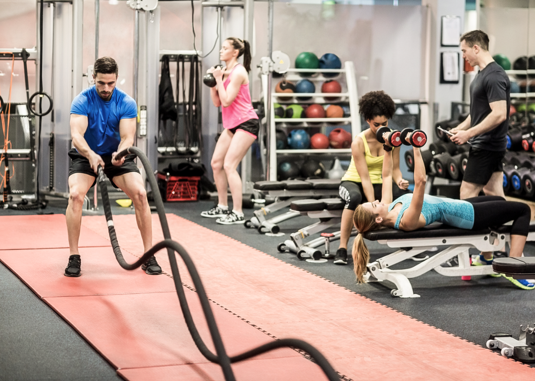 five people working out in a gym on doing different exercises