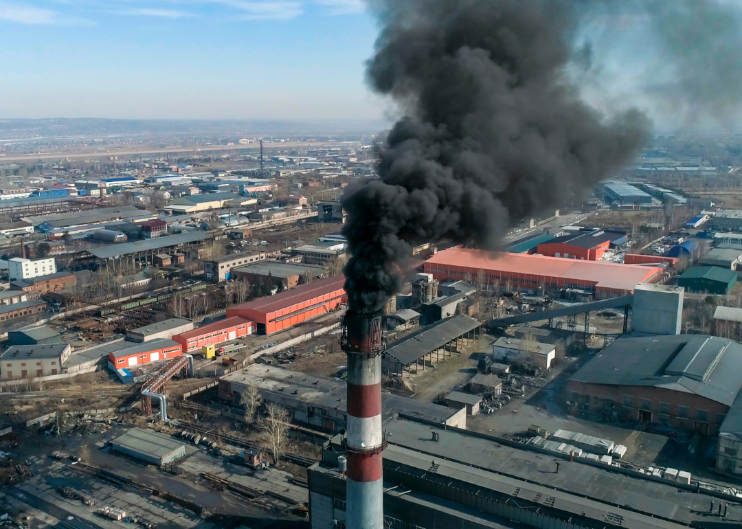 dark smoke rises out of smokestack of coal-fired plant