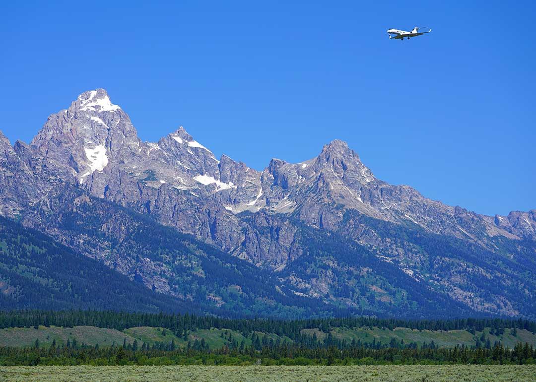 private jet approaching landing near Grand Teton mountains in Jackson Hole, WY