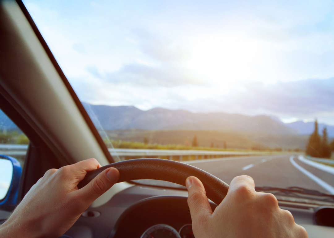 POV of driver looking at road over steering wheel
