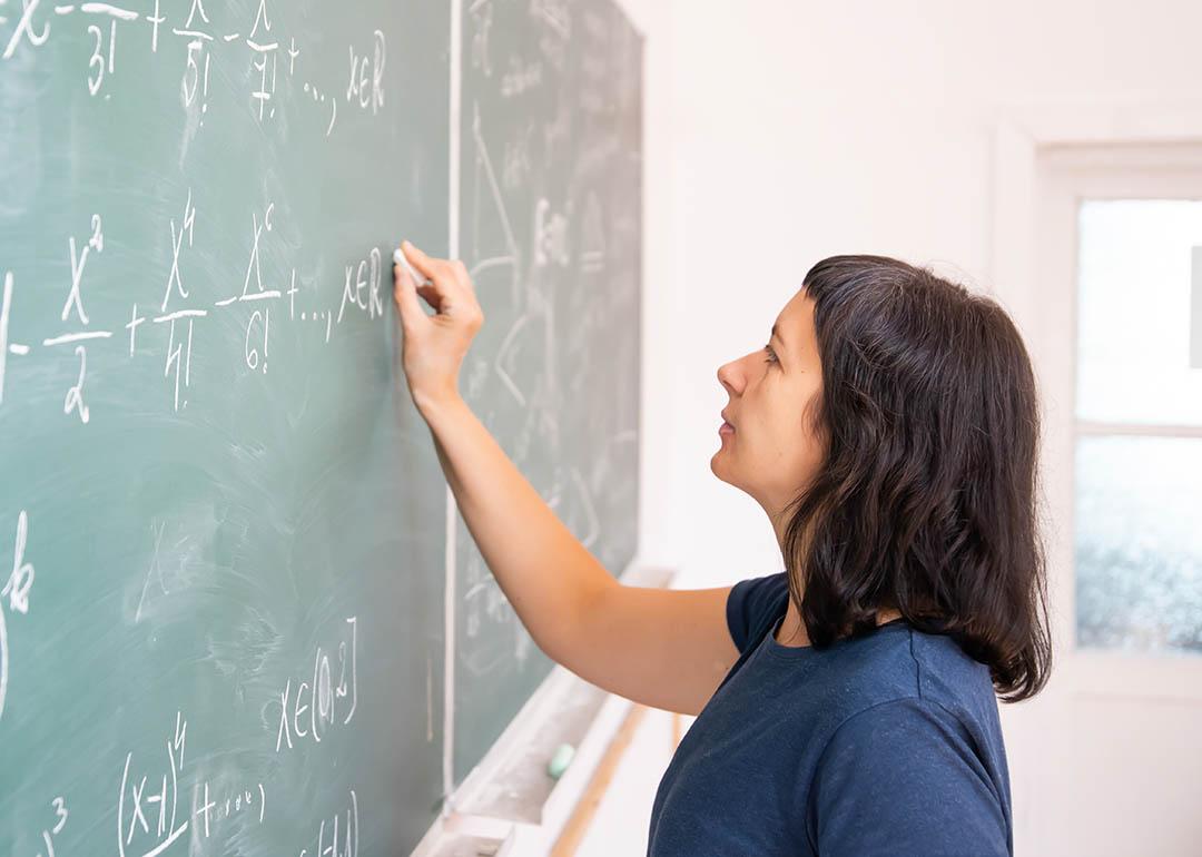 math teacher writing on board
