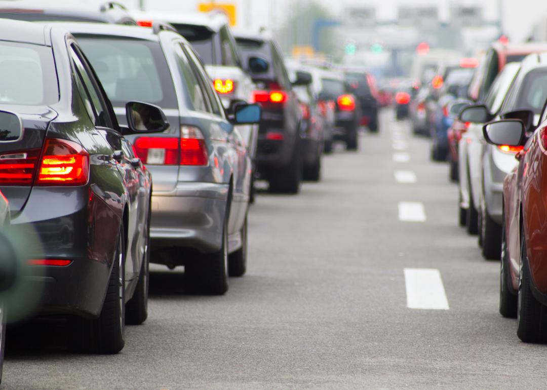 Two lanes of cars in a traffic jam on a highway.