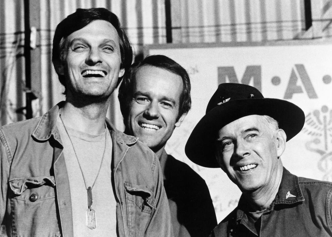 Actors Alan Alda, Mike Farrell, and Harry Morgan on the set of 'M*A*S*H' in 1975.